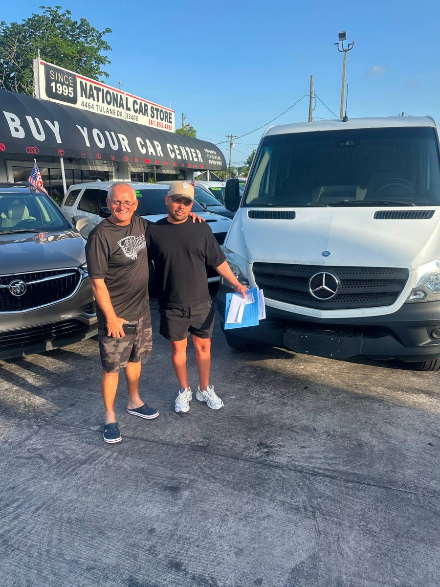 Two men with a Mercedes Sprinter van in front of National Car Store